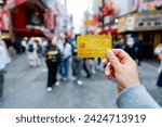 Small photo of Travel card, Tourist woman showing credit card or travel card for convenient travel Make shopping easy enjoy lifestyle travel city at shopping street on holiday vacation in Japan