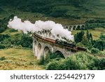Small photo of Jacobite steam train crossing the Glenfinnan Viaduct with steam rising from the chimney. Hogwarts Express, Harry Potter.