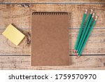 Fridge stickers, notepads and green pencils on a brown wooden background. Stationery, notes and organizer for business, motivation and training
