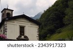 Small photo of Italian Landscape: Tiny alpine village. Treasure in Bergamo province alpine area. Valle Brembana rural hamlet. Mountains and streams... Churches, rural architecture, rural life, brigde, small stream.