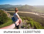 Follow me concept - Woman wanting her boyfriend to follow her in travel on the top of mountain in Altai