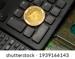 Dogecoin token coin on a black keyboard with a scientific calculator and electronic board. Crypto Currency symbol and techno gadgets. Opposite side