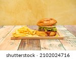 Small photo of A hamburger is a sandwich made from ground meat or of vegetable origin, agglutinated in the form of a steak cooked on the grill or on the grill, although it can also be fried or baked