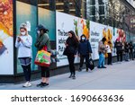 Small photo of NEW YORK, NEW YORK - APRIL 01, 2020: A long line outside of Whole Foods in Tribeca, New York as the store has implemented social distancing measures during the COVID-19 pandemic.