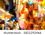 Decorated colorful lanterns hanging on a stand in the streets of Cholon in Ho Chi Minh City, Vietnam during Mid Autumn Festival. Chinese language in photos mean money and happiness. Selective focus.