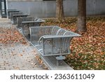 a gorgeous autumn landscape at Nashville Public Square Park with fallen autumn leaves, metal benches and a cobblestone footpath in Nashville Tennessee USA