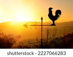 Rooster weather vane at sunrise ...