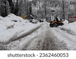 Small photo of Solang Nullah, Himachal Pradesh, India - March 14, 2020: A man navigates an all terrain vehicle in a remote village snowed in by heavy snowfall