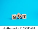 mst text on wooden blocks, business concept, blue background