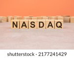 Small photo of Word cubes lined up with the letters NASDAQ written on it. Copy space available. NASDAQ - National Association of Securities Dealers Automated Quotation