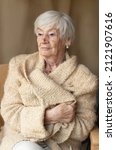 Small photo of Portrait of a self-confident elderly ,goody -goody woman after 85 in a beige knitted cardigan.