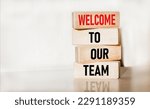 Small photo of Welcome to the symbol of our team. Concept words Welcome to our team on wooden blocks. Beautiful background. Copy space.