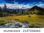 Mountain valley on a clear day. Beautiful valley in mountains. Mountain valley landscape. Snowy mountain peaks background