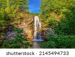 Waterfall in the forest landscape. Beautiful forest waterfall landscape. Waterfall cascade in forest. Waterfall view