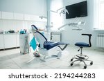 Small photo of Dental equipment in dentist office in new modern stomatological clinic room. Background of dental chair and accessories used by dentists in blue, medic light. Copy space, text place