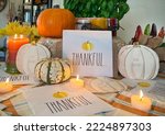 Small photo of Thankful and Give Thanks table decorations with candles to commemorate Autum and Thanksgiving Holidays