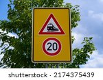 Small photo of The traffic sign means unrestricted train crossing. The speed limit is 20. Beware of the unrestricted tram crossing. Trains and trams have priority.