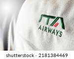 Small photo of Rome, Italy, July 2022: The logo of the airline ITA Airways sewn on the headrest of an aircraft. ITA Airways is the Italian flag carrier