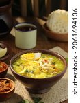 Small photo of soto ayam Indonesian traditional dish,shredded chicken with slice cabbage,bean sprouts,vermicelli,which is doused with yellow soup,with a complement crackers and chili sauce