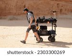 Small photo of AL ULA, SAUDI ARABIA - March 2023. TV crew from Qatar at the extraordinary Hegra Archaeological Site. Civilizations have been developing here for 200,000 years. UNESCO List 2008.