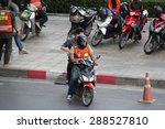 Small photo of Bangkok, Thailand - April 28, 2015: Motorcycle Taxis, with orange vests, are common form of public transportation in Bangkok. Locals use the service when they need to get somewhere fast.