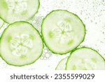 sliced cucumbers float on the surface of the water