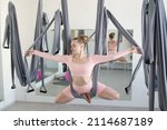 aero yoga training on suspended cloths in the form of a hammock is stretching and strengthening muscles, ligaments and joints, elements of yoga, pilates, gymnastics and aerial acrobatics