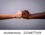 Two fists, one white and one black touching, concept of fight against racism