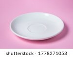 White saucer on a pink...