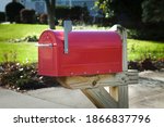 Red rural mailbox on a brown...