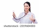 Small photo of Professional young Asian woman doctor wears medical coat while is showing hand as thump up to present something isolated on white background in health protection concept.