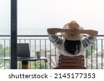 Small photo of Work-Life balance, life quality, work from home and travel concept with business woman relaxing, take it easy, resting in hotel resort, condominium, or apartment luxury living room with notebook