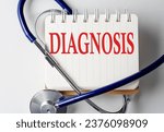 DIAGNOSIS word on a notebook with medical equipment on background