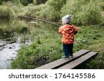 A Boy Stands On A Bridge By The ...