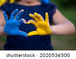 Love Ukraine concept. hands in heart form painted in Ukraine flag color - yellow and blue. Selecrive focus. Independence day of Ukraine, Flag, Constitution day Education, school, art painitng concept