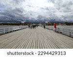 Small photo of Sopot,Poland- may 21,2022:streets and buildings of the city of Sopot on a cloudy rainy day before the beginning of the tourist season, Sopot molo.pier