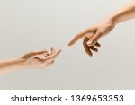 Moment of weightless. Two male hands trying to touch like a creation of Adam sign isolated on grey studio background. Concept of human relation, community, togetherness, symbolism, culture and history