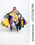 Small photo of Shopping like an issue. Man addicted of sales. Overproduction and crazy demand. Female model wearing too much colorful clothes, need more. Fashion, style, black friday, sale, abusing purchases.