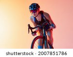 Young female cyclist riding a...