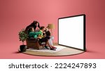 Small photo of Happy young people, emotional friends watching football match, sport show. Youth sitting on sofa in front of huge 3D model of tv screen. Concept of sport, leisure activities, betting, ad