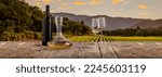 Small photo of Bottle, decanter and two glasses with white wine standing on wooden table over beautiful nature landscape of fields and forest. Summertime. Traditions of winemaking, degustation, taste