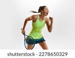 Small photo of Happiness. Winner. Portrait of young woman, professional female tennis player in uniform posing with tennis racket against white studio background. Concept of professional sport, movement, action. Ad