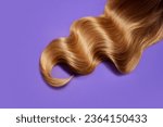 Small photo of Ply of shiny, healthy, glowing blonde hair with wavy styling on purple background. Professional hair treatment. Concept of hair care, organic products, natural beauty, cosmetics. Ad. Poster.