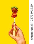 Small photo of Traditional taste. Woman holding fork with spaghetti and meatball over yellow background. Tomato sauce and basil. Concept of Italian food, cuisine, taste, cooking, menu. Pop art. Poster, ad
