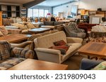 Small photo of Sweden, Hanaskog – December 12, 2022: A big second hand store, a lot of used furniture sofas, chairs, tables, cupboards. Wooden furniture storage, warehouse. Vintage things.