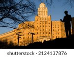 Small photo of Hot Springs, Arkansas - February 6, 2022: Hot Springs National Park's Hill Wheatley Plaza statue and the Arlington Resort Hotel and Spa