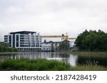 Small photo of Belfast, Northern Ireland - June 8 2022: Belfast cityscape with a view of a famous HW yellow crane and Titanic Museum