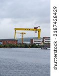 Small photo of Belfast, Northern Ireland - June 8 2022: Belfast cityscape with a view of a famous HW yellow crane and Titanic Museum