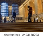 Small photo of New York, NY USA - April 22, 2022: New York City, Commuters and Tourists Masked and Unmasked in Grand Central Terminal During Second Year of Covid-19 Pandemic