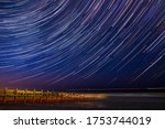 Hornsea Beach on the Yorkshire coast under a beautiful night sky, dramatic long exposure astrophotography showing beautiful stars & star trails